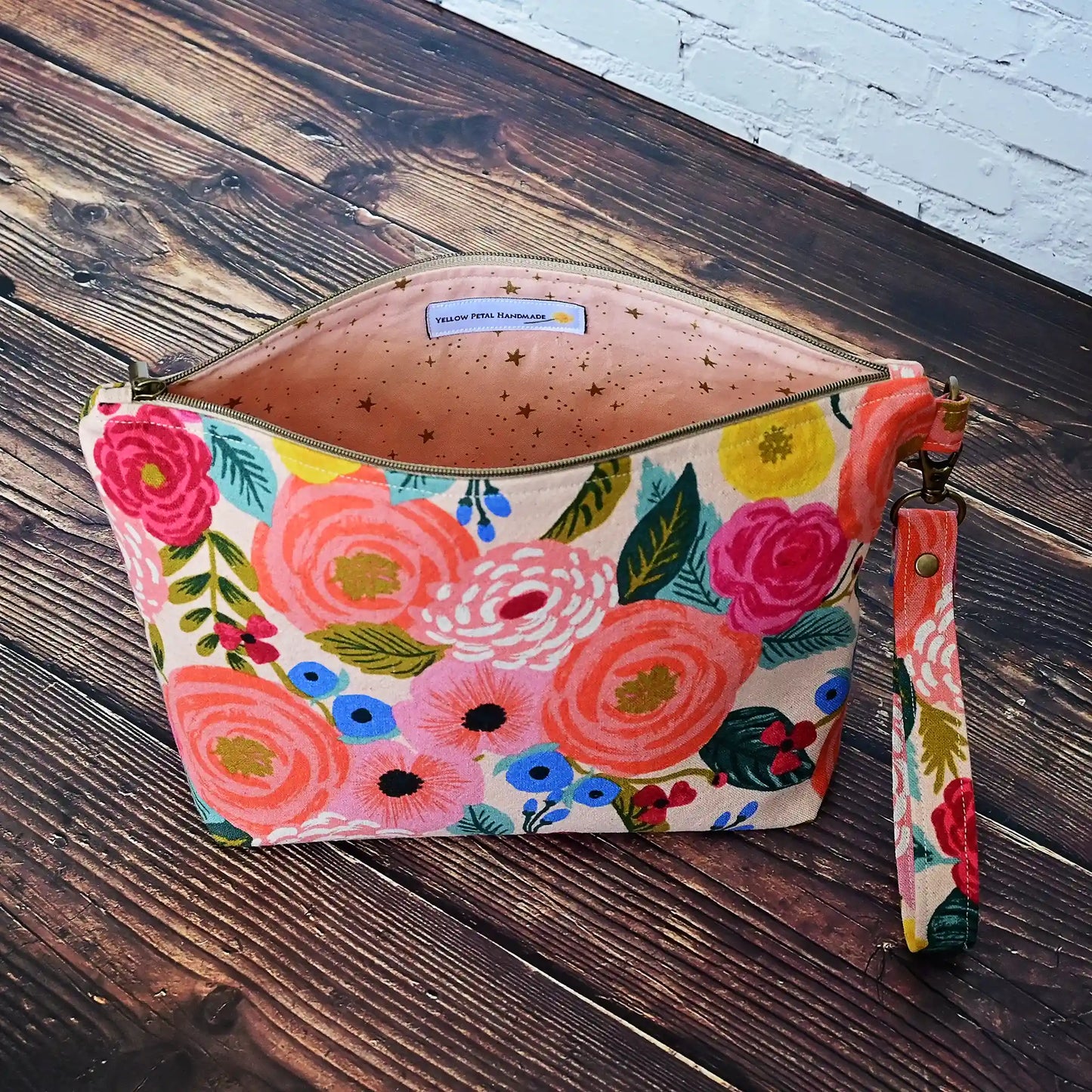 Pretty peach floral canvas pouch with removable wrist strap.  Lined in peach cotton with Gold Stars.  All fabrics from Rifle Paper Co.  Made in Nova Scotia, Canada by Yellow Petal Handmade.