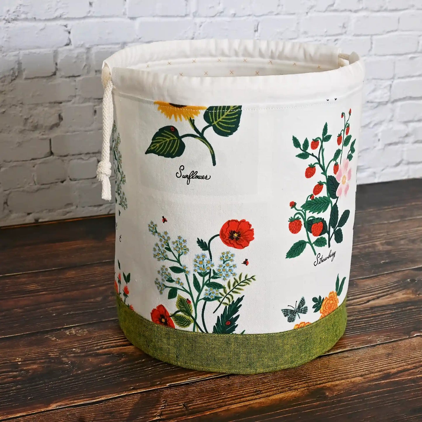 Stunning white floral project bag with green base and tons of pockets!  Great for needlework projects.  Made in Canada by Yellow Petal Handmade using Rifle Paper Co's Curio fabric collection.