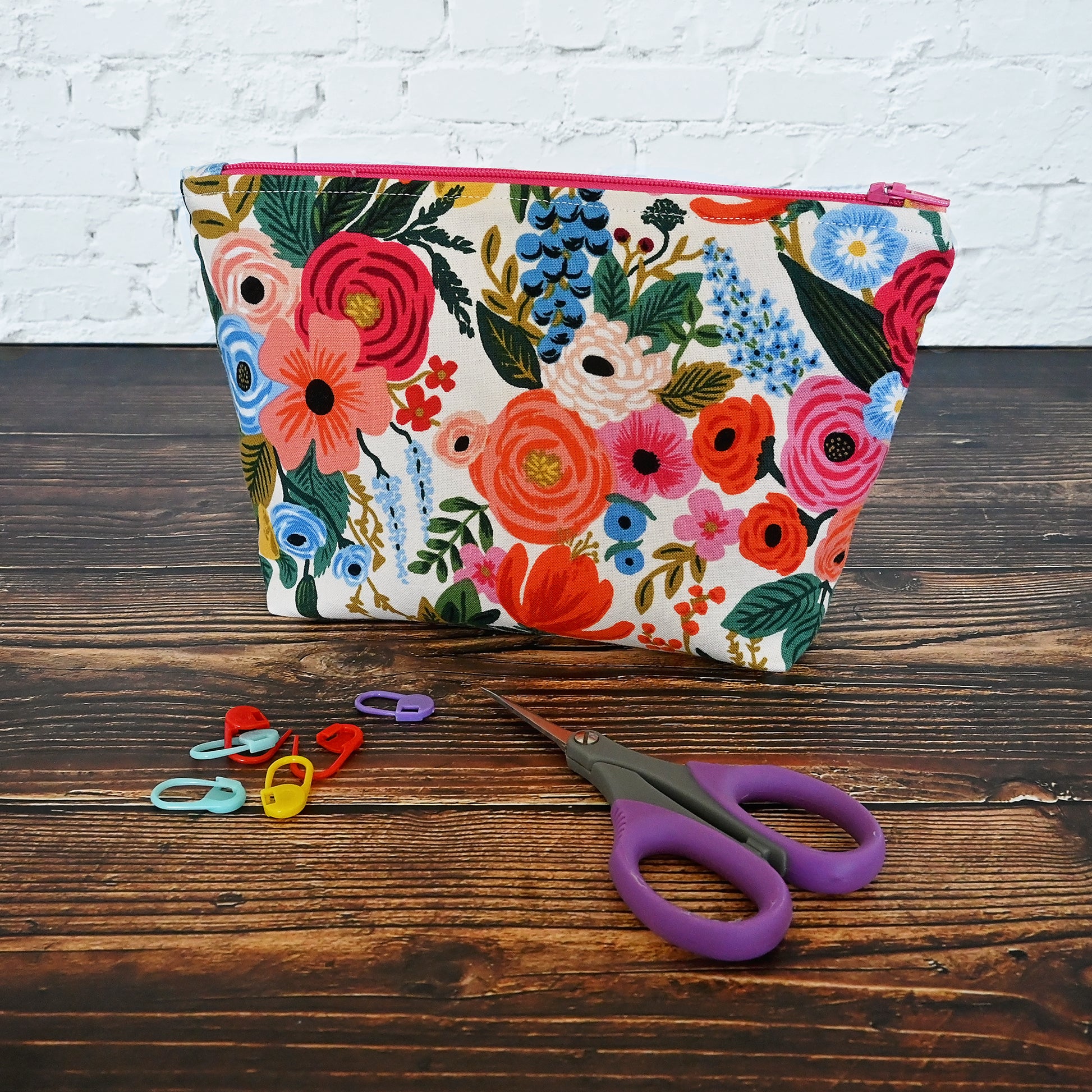 Pretty floral pouch in Rifle Paper's Garden Party fabric.  This pouch has a lovely raspberry coloured lining and zipper to match.  It's perfect for carrying all of your small accessories.