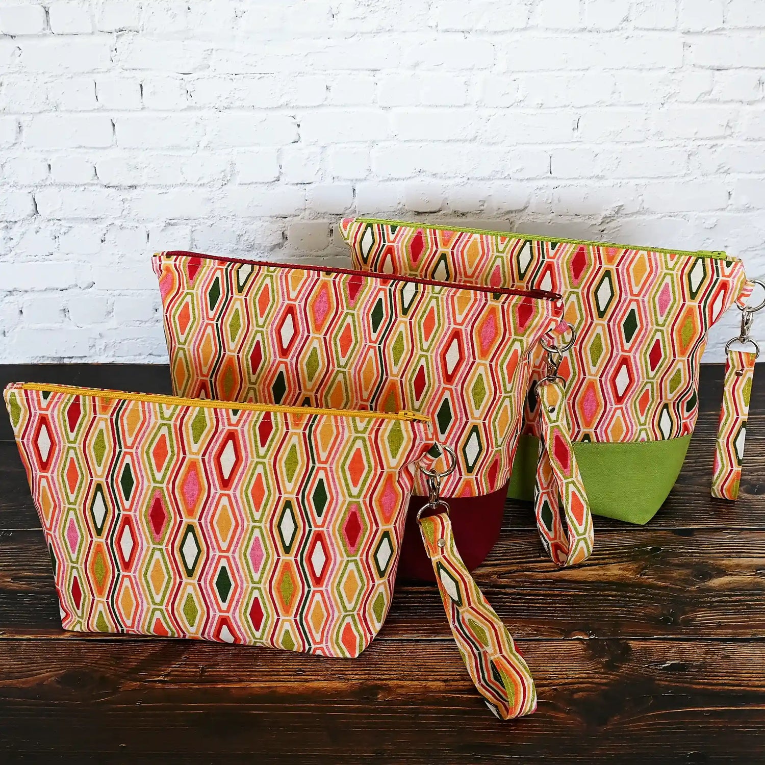 Collection of jewel toned project bags with removable wrist straps in a fun retro print.  Made in Canada by Yellow Petal Handmade.