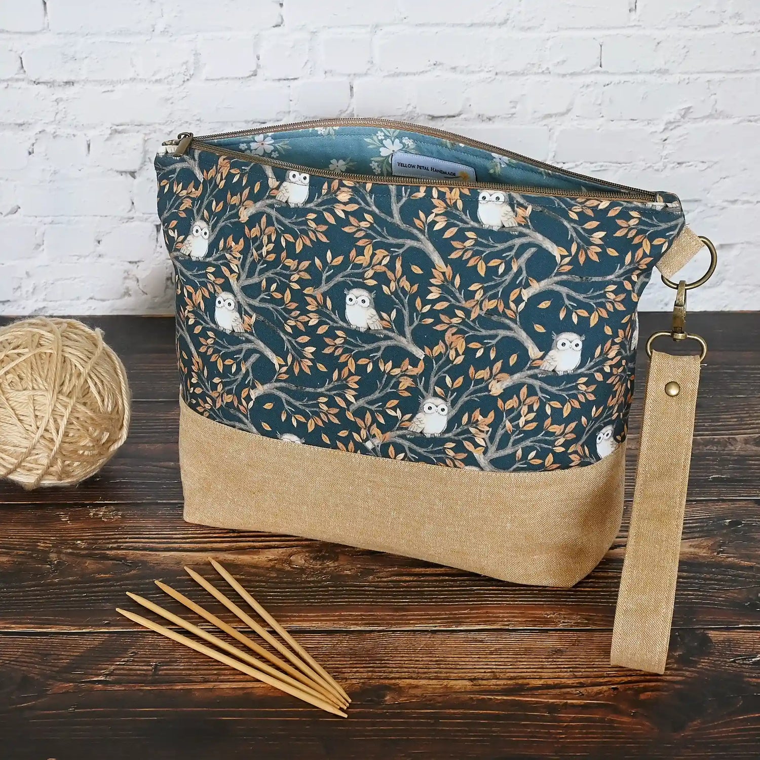 Large zippered project bag pouch in adorable navy owl fabric and paired with a linen base and removable wrist strap.  Made in Canada by Yellow Petal Handmade.