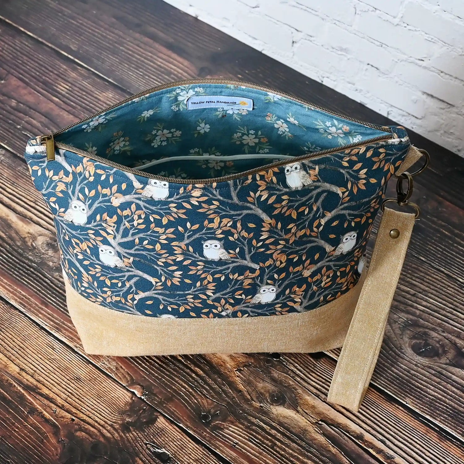  Large zippered project bag pouch in adorable navy owl fabric and paired with a linen base and removable wrist strap.  Made in Canada by Yellow Petal Handmade.
