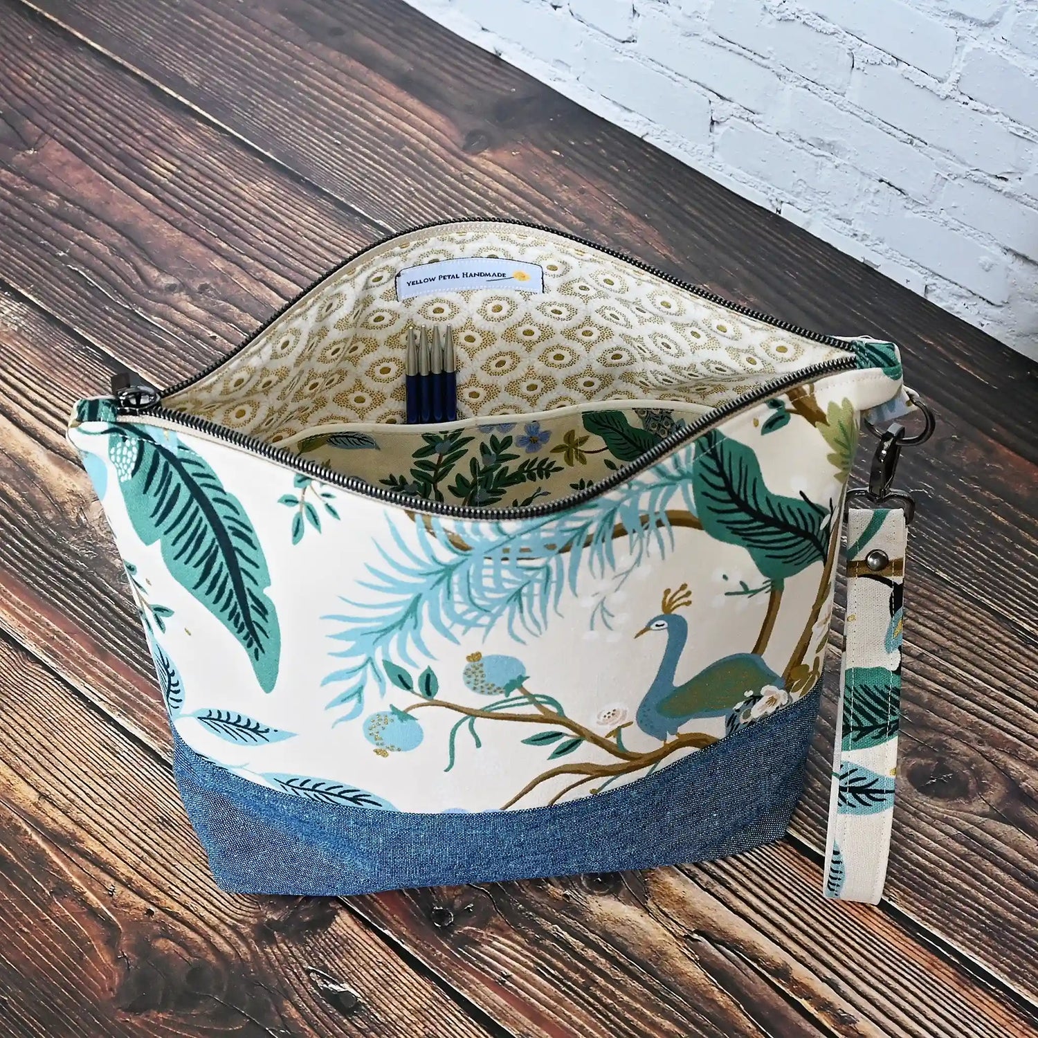 Beautiful two tone canvas and linen knitting project bag in Rifle Paper Co's Antique Garden fabric featuring green and teal florals and peacocks.  Handmade in Canada by Yellow Petal Handmade.
