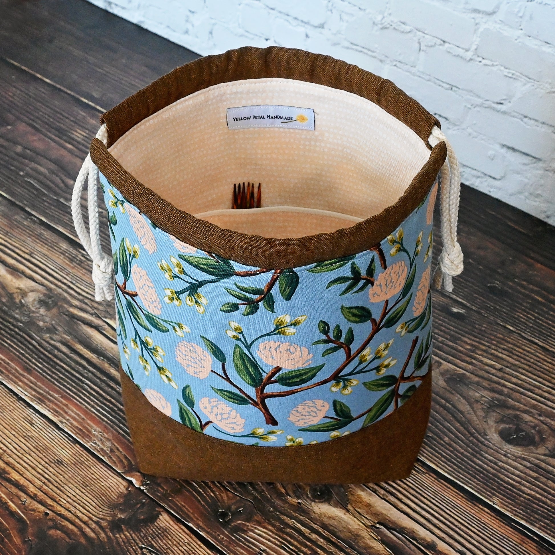 Pretty floral project bag in peonies fabric by Rifle Paper Co, paired with a lovely brown linen from Robert Kaufman.  This bag is lined with a pale peach fabric and closes securely with a double drawstring.  Made in Canada by Yellow Petal Handmade.