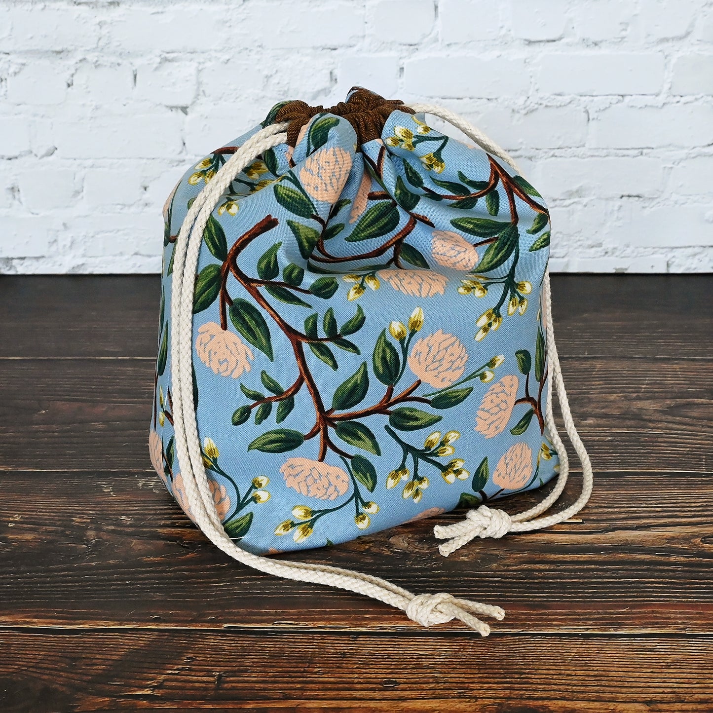 Pretty blue and peach drawstring project bag made from Peonies fabric by Rifle Paper Co.  Lined in a pale peach dotted fabric.  Made in Canada by Yellow Petal Handmade.