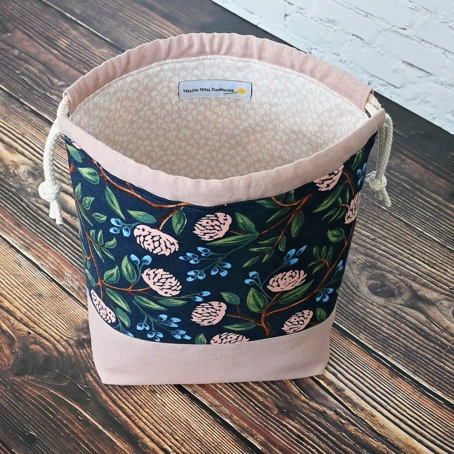 Pretty drawstring project bag made from a navy cotton with pink peonies and paired with a matching pink linen bottom.  Available with or without pockets.  Made by Yellow Petal Handmade in Nova Scotia, Canada.