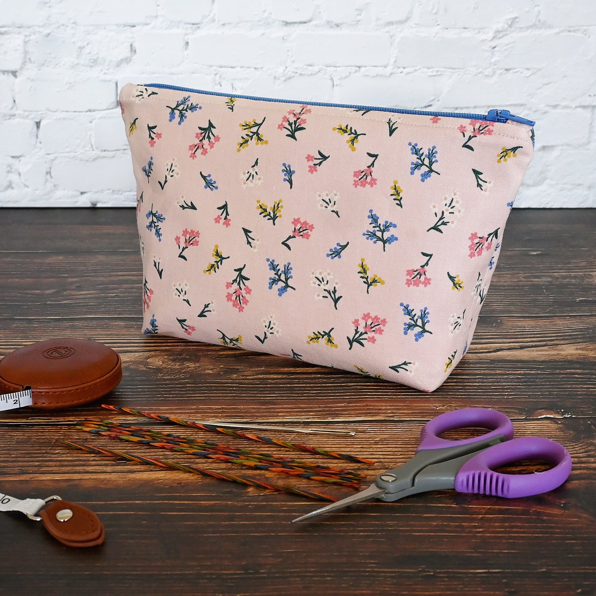 Pretty pink floral accessory pouch in Rifle Paper's Strawberry Fields collection.  Closes with a blue zip and lined in a pretty pink and cream striped cotton.