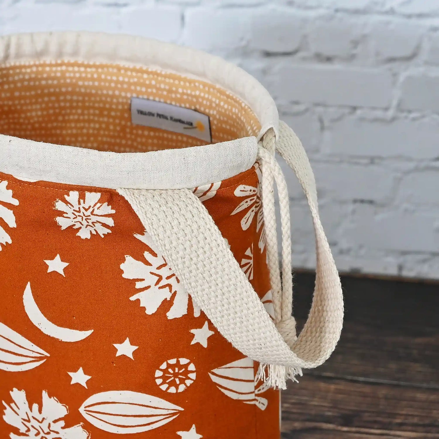 Beautiful drawstring project bag with handle in a burnt orange floral and star fabric and lined in a fun gold dotty cotton.  Handmade in Nova Scotia Canada by Yellow Petal Handmade.