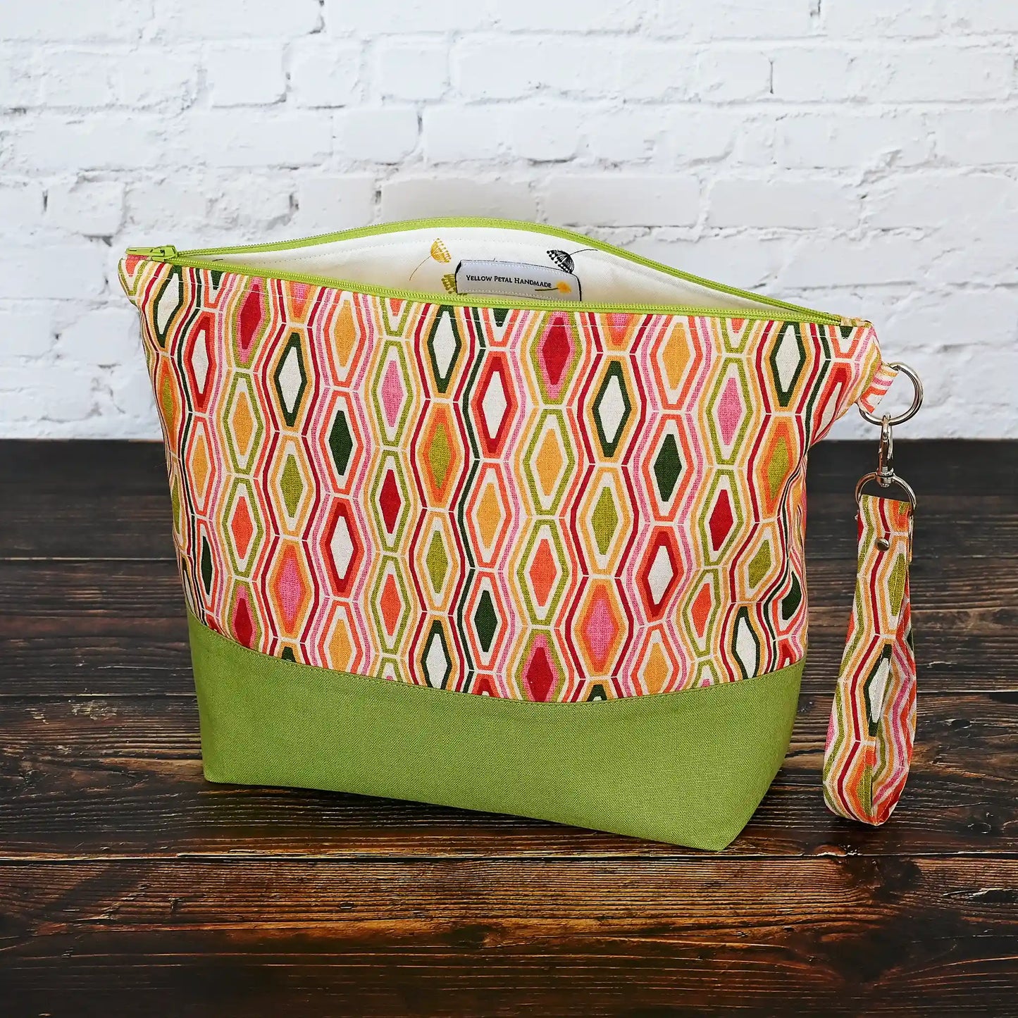 Beautiful jewel toned project bag in an eye catching retro fabric and paired with a beautiful green linen.  Made in Canada by Yellow Petal Handmade.
