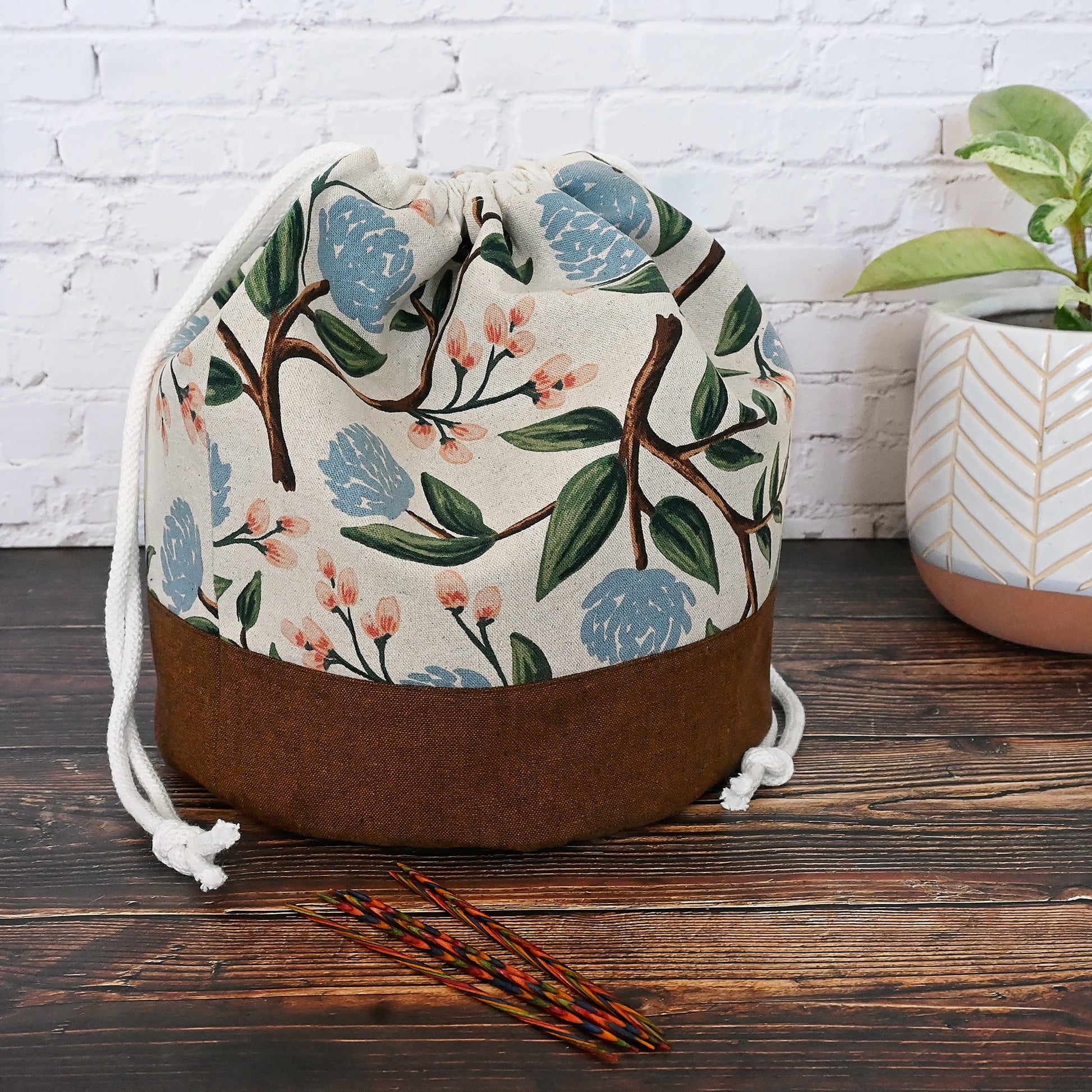 Lovely natural canvas and linen bucket style project bag made from Rifle Paper Co's Peony fabric.  Lined in an unbleached cotton and has multiple slip pockets in a pretty blush and while floral.  This bag closes securely with a double drawstring and has a quilted bottom for stability as well as a fun design feature.  Made in Nova Scotia Canada by Yellow Petal Handmade.