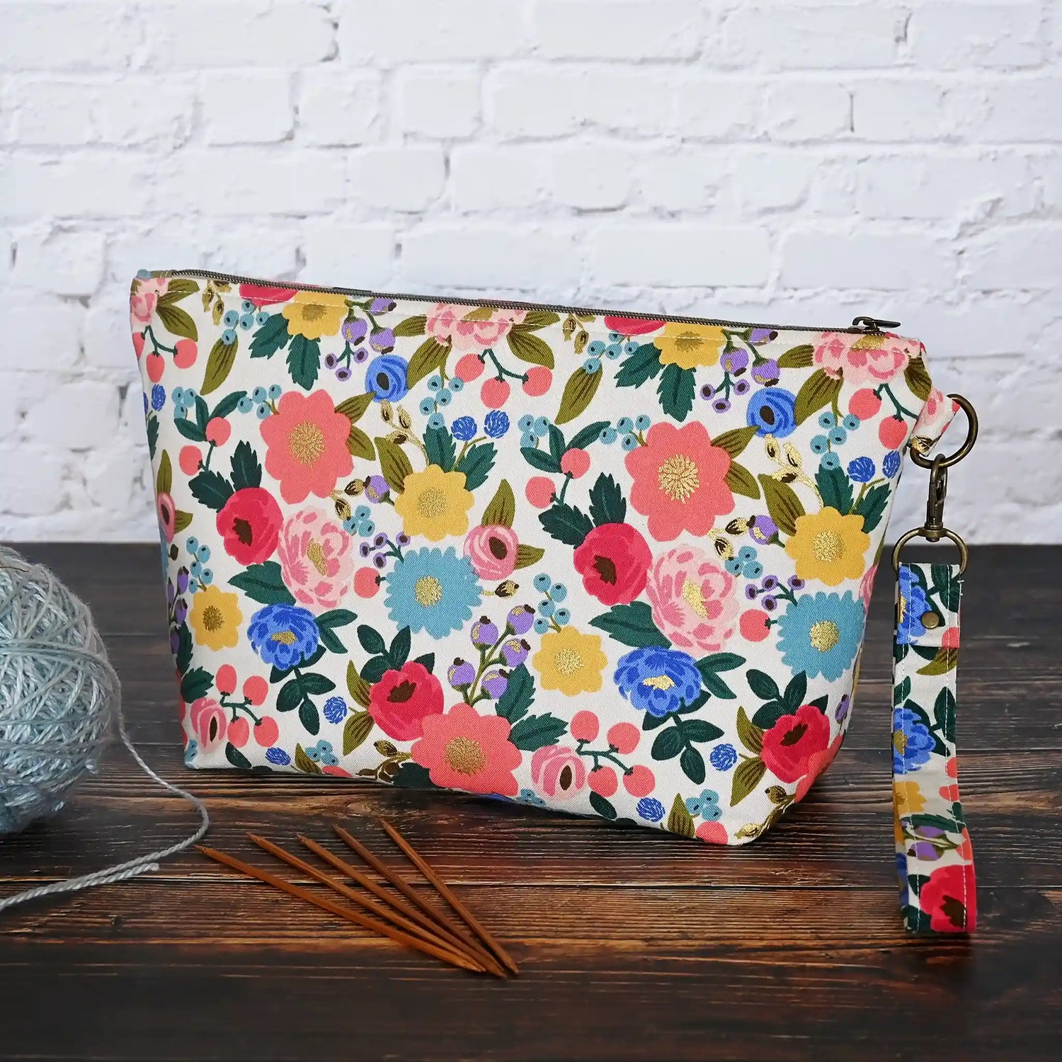 Pretty cream floral zippered pouch with wrist strap in fabrics from Rifle Paper Co's Antique Garden collection.  Handmade by Yellow Petal Handmade in Canada.