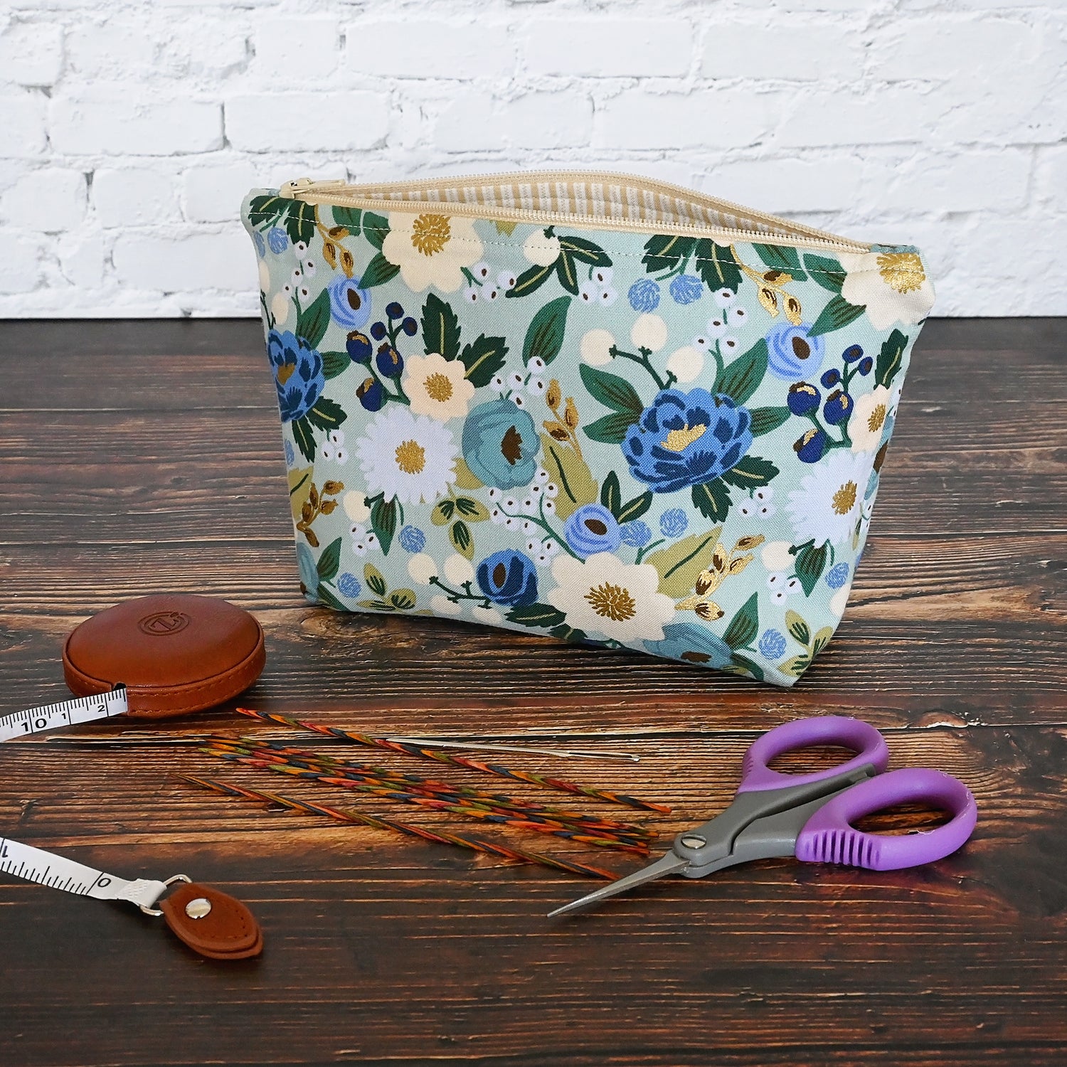 Vintage Garden Accessory pouch in a lovely aqua floral fabric.  Closes with a zipper and is lined in a gold and cream striped cotton.  Made in Canada by Yellow Petal Handmade.