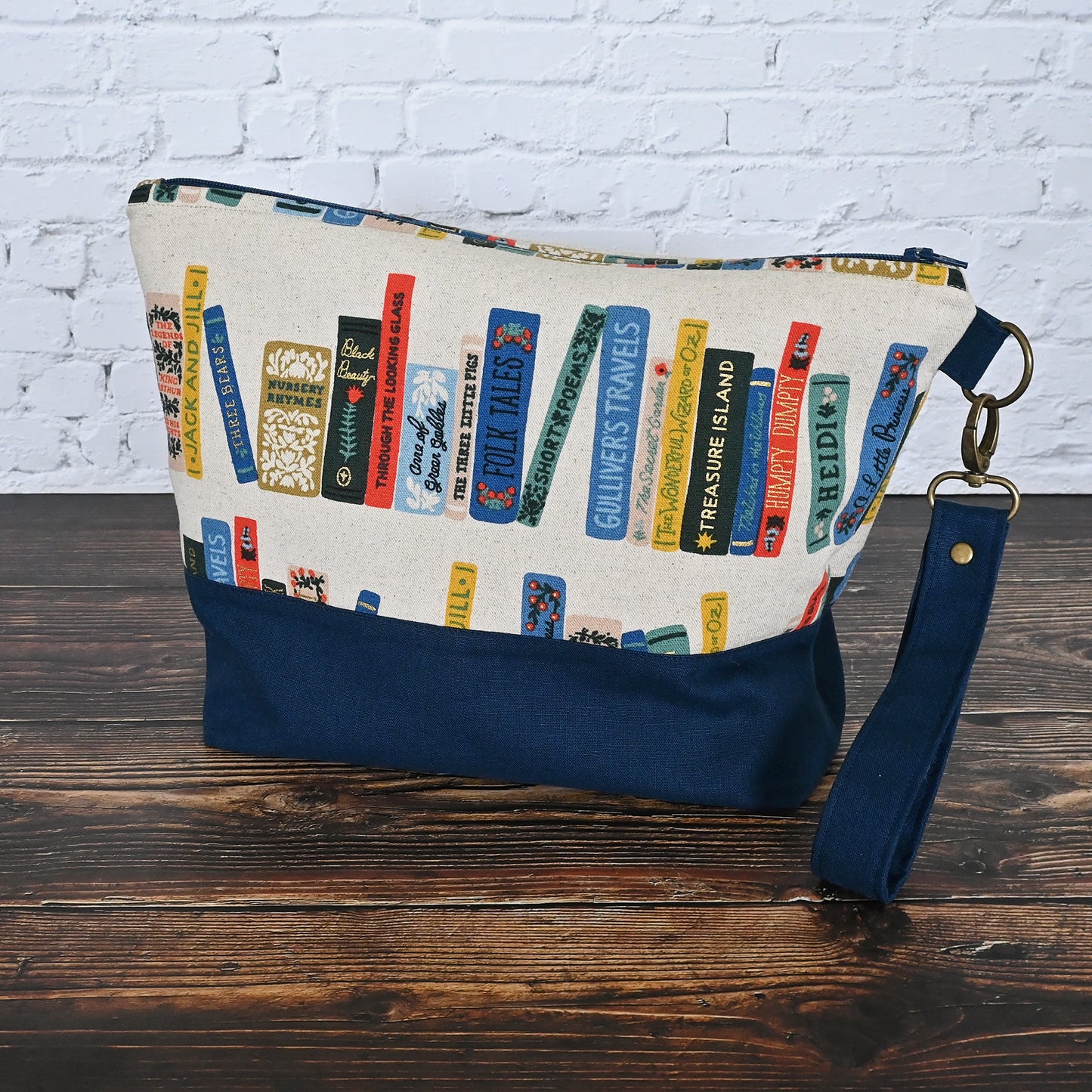 Fun project bag in Rifle Paper's Book Club Canvas.  Paried with a lovely navy linen and lined in an unbleached cotton with cotton Book Club Pockets.  Comes with a removable wrist strap.  Made in Canada by Yellow Petal Handmade.