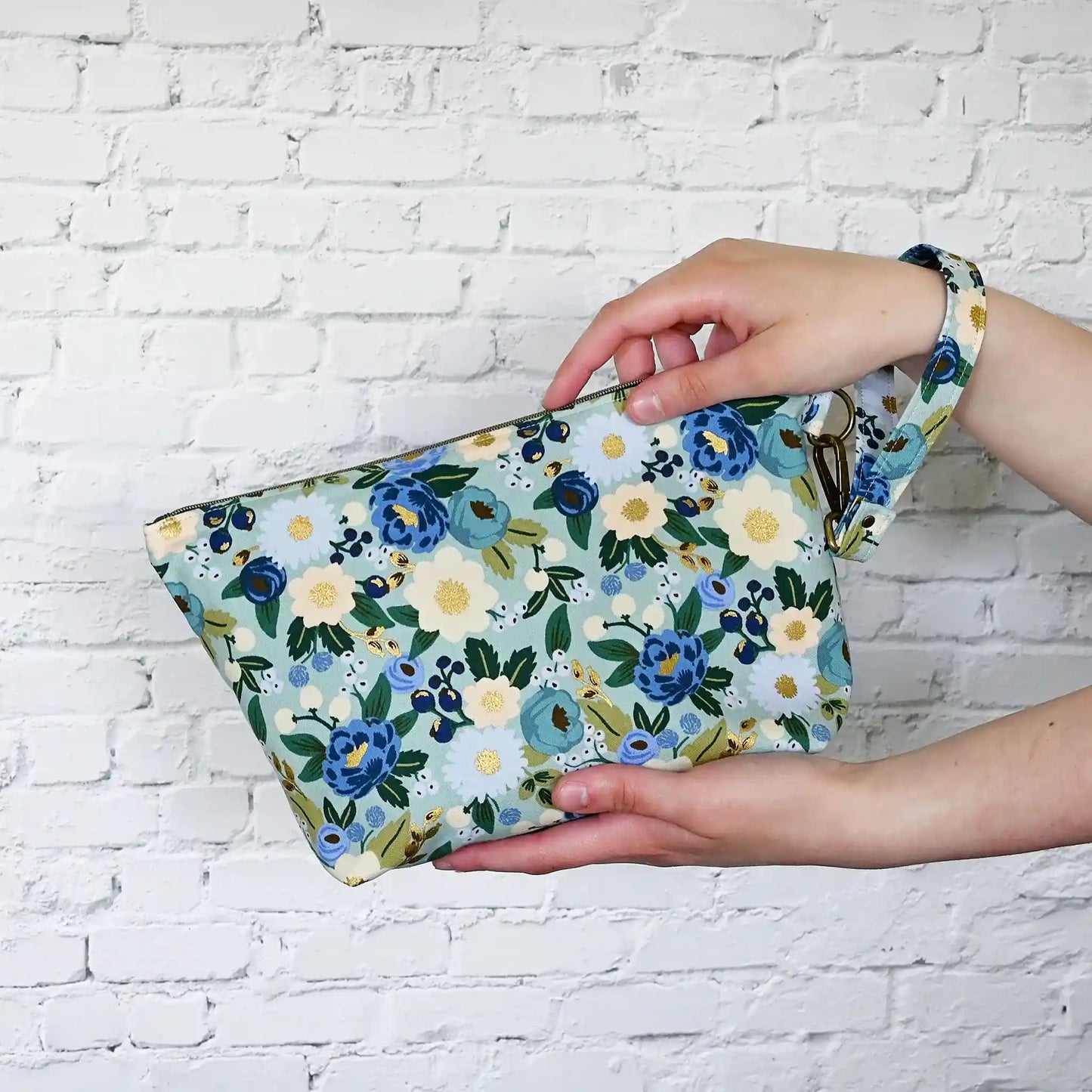 Beautiful pouch in an aqua floral fabric with gold detailing by Rifle Paper Co.  Handmade in Nova Scotia, Canada by Yellow Petal Handmade.