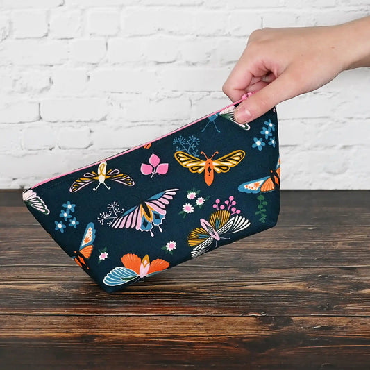 Beautiful navy accessory pouch with butterflies.  Lined in a pretty aqua floral and adorned with a pink zipper.  Made in fabrics by the Ruby Star Society.  Handmade in Canada by Yellow Petal Handmade.