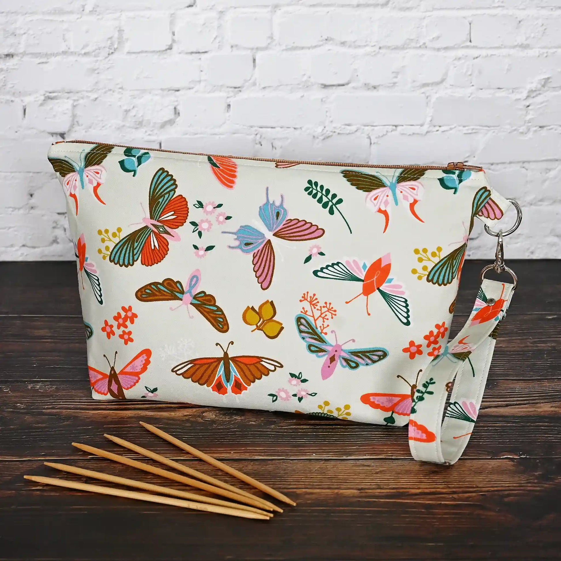 Gorgeous cream pouch with removable strap.  Made from a striking butterfly patterned cotton and lined in a pretty cream floral, both by Ruby Star Society.  Made in Canada by Yellow Petal Handmade.