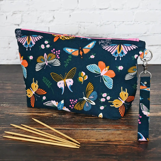 Gorgeous navy pouch with removable strap.  Made from a striking butterfly patterned cotton and lined in a pretty aqua floral, both by Ruby Star Society.  Made in Canada by Yellow Petal Handmade.