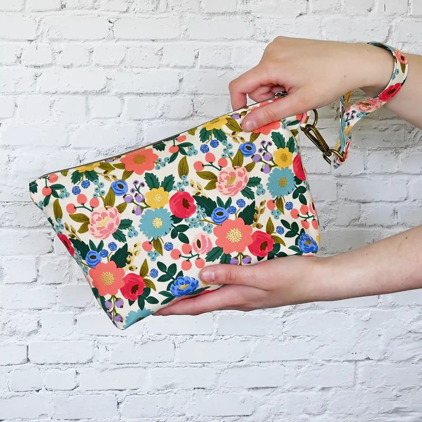 Pretty cream floral zippered pouch with wrist strap in fabrics from Rifle Paper Co's Antique Garden collection.  Handmade by Yellow Petal Handmade in Canada.