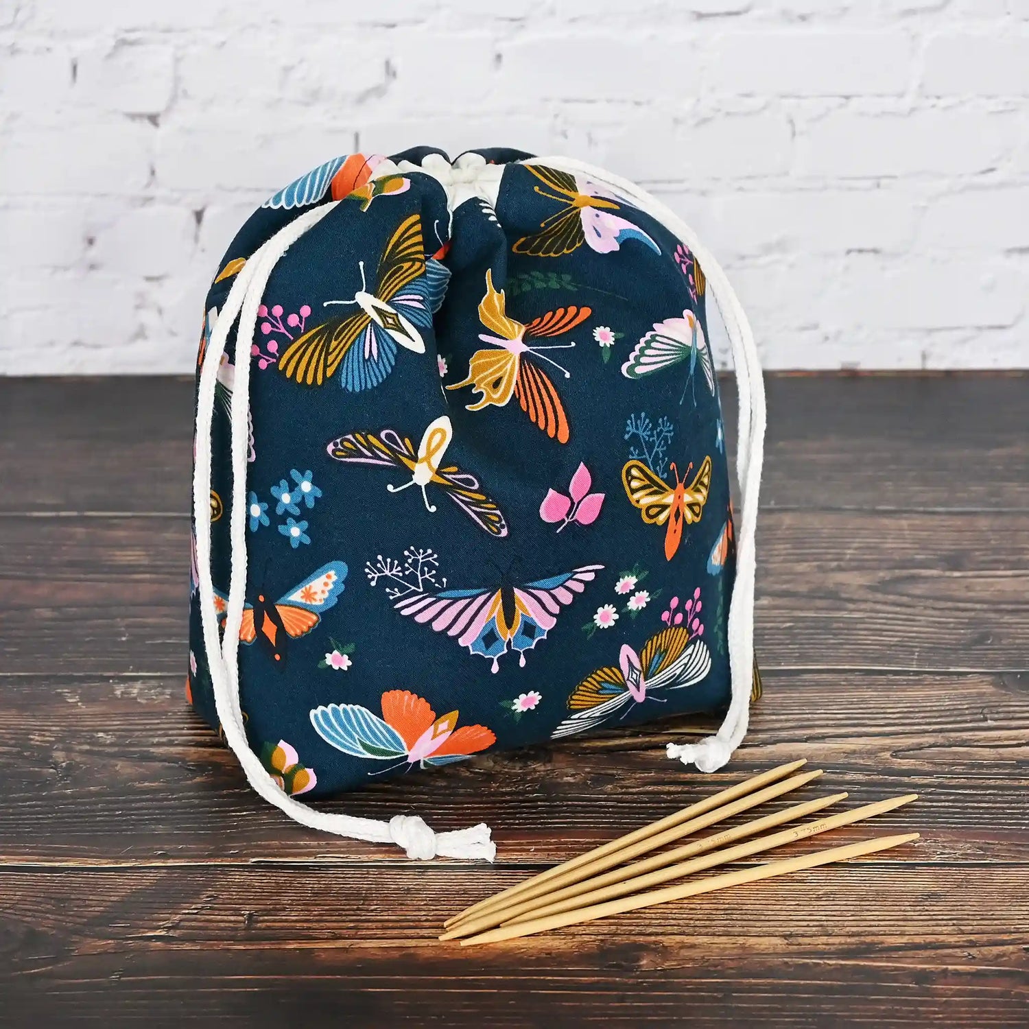 Beautiful butterfly themed drawstring project bag, lined in a pretty aqua floral and with pockets.  Made in Canada by Yellow Petal Handmade.