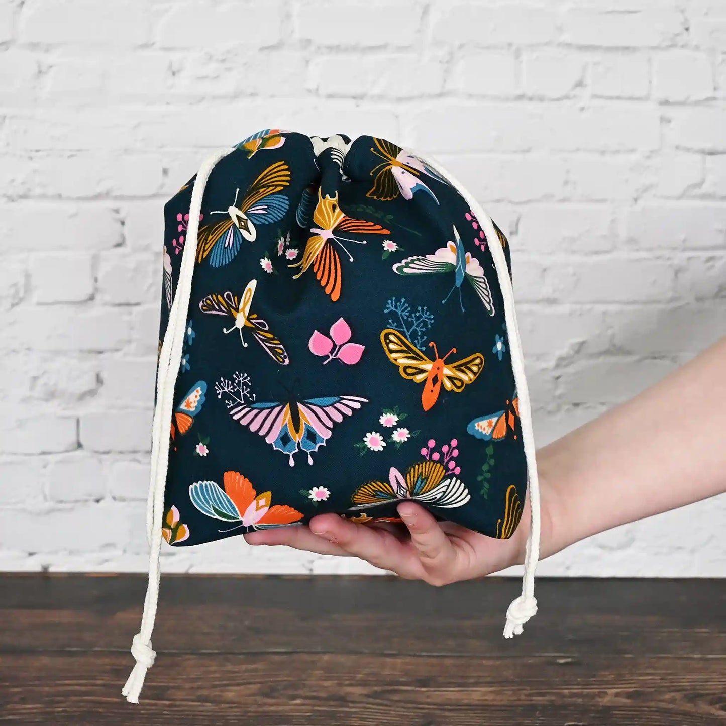 Beautiful butterfly themed drawstring project bag, lined in a pretty aqua floral and with pockets.  Made in Canada by Yellow Petal Handmade.