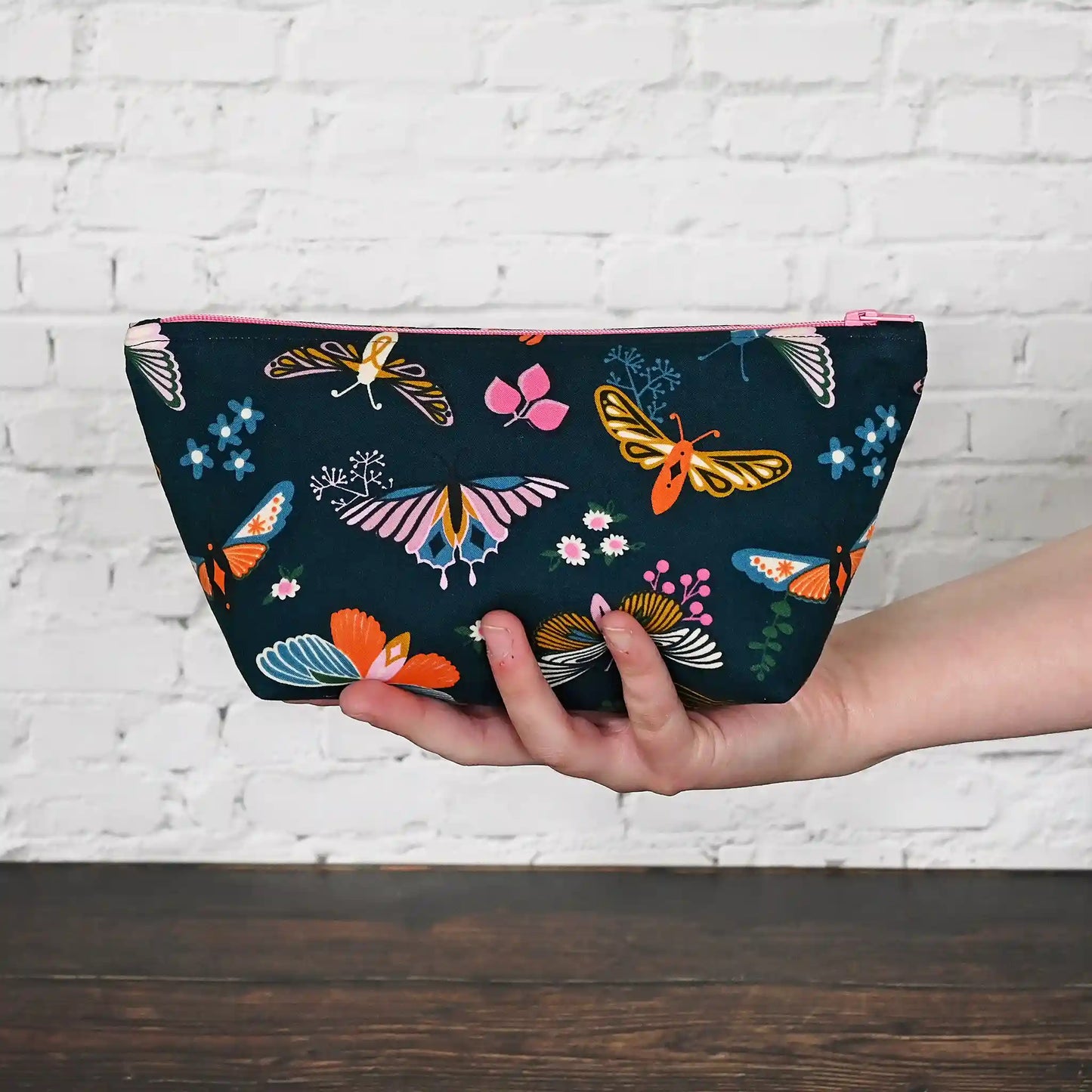 Beautiful navy accessory pouch with butterflies.  Lined in a pretty aqua floral and adorned with a pink zipper.  Made in fabrics by the Ruby Star Society.  Handmade in Canada by Yellow Petal Handmade.