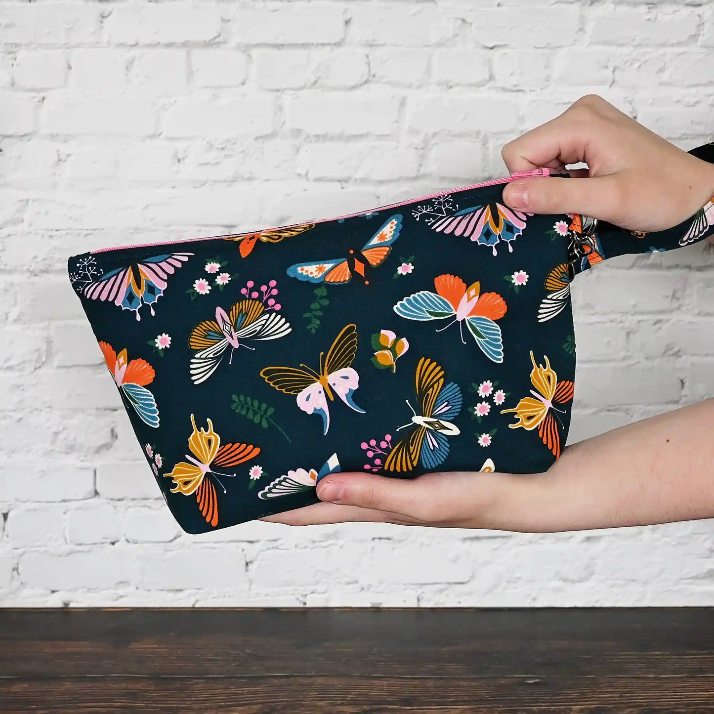 Gorgeous navy pouch with removable strap.  Made from a striking butterfly patterned cotton and lined in a pretty aqua floral, both by Ruby Star Society.  Made in Canada by Yellow Petal Handmade.