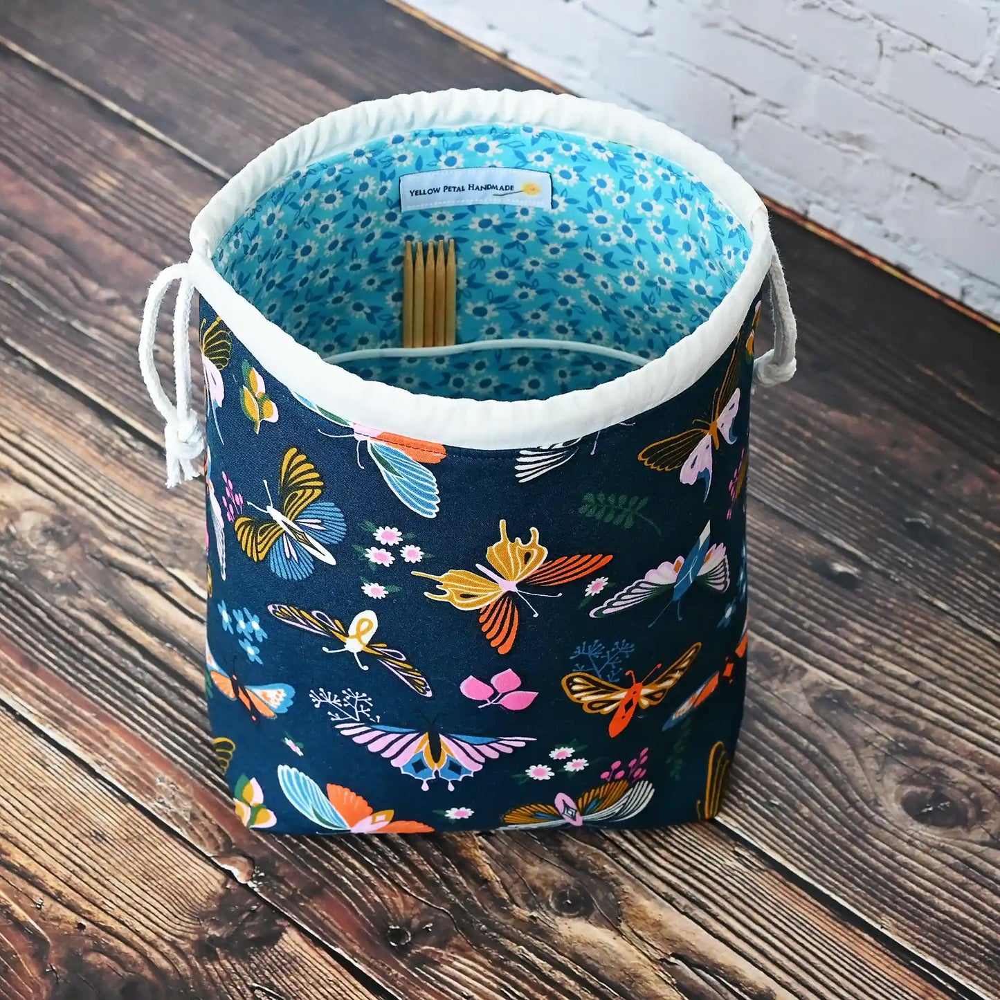 Beautiful butterfly themed drawstring project bag, lined in a pretty aqua floral and with pockets.  Made in Canada by Yellow Petal Handmade.