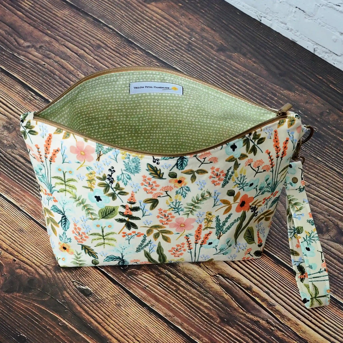 Zippered pouch with removable strap in Rifle Paper's Herb Garden Fabric.  Lined in a pale green dotty fabric.  Made in Canada by Yellow Petal Handmade.