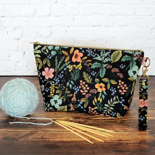 Pretty black floral canvas zippered pouch with removable strap.  Lined in a pretty aqua floral cotton.  Made in Canada by Yellow Petal Handmade.