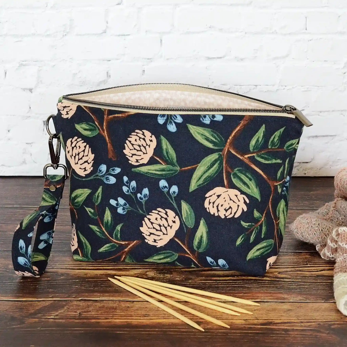 Navy canvas pouch made from peonies fabric from Rifle Paper Co and lined with a pale blush and white flowered cotton.  Comes with removable strap.  Made in Canada by Yellow Petal Handmade.