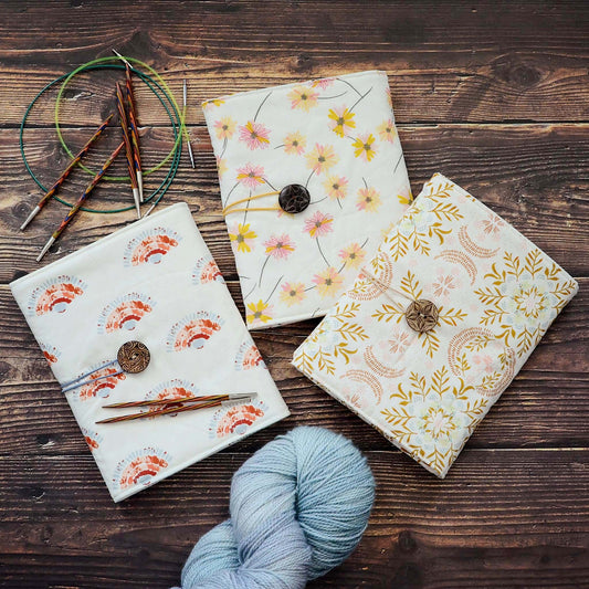 Quilted knitting needle wraps in premium Art Gallery Fabric.  Three different designs, all with an elastic and button closure.  Made in Canada by Yellow Petal Handmade.
