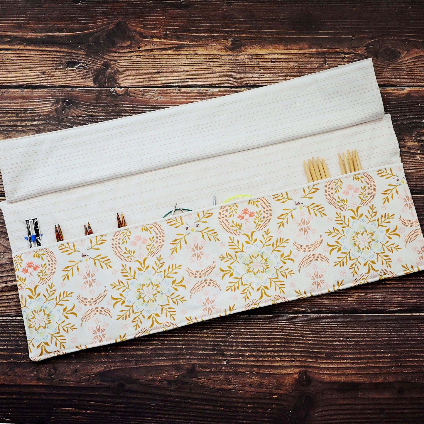 Quilted needle wrap in premium Art Gallery Fabric with a gorgeous cream, pink and gold geometric pattern.  Made in Canada by Yellow Petal Handmade.