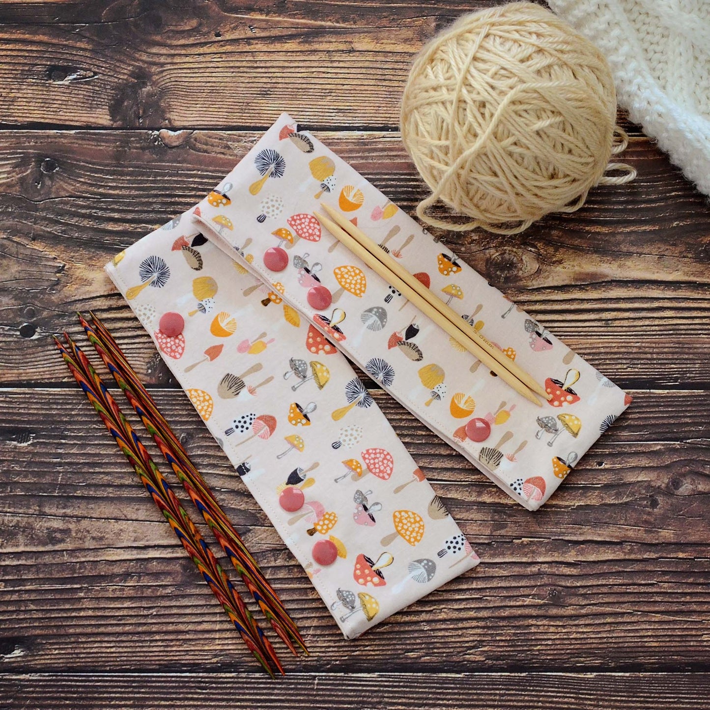 Mushroom themed dpn cozy with snaps for varying lengths of double pointed needles.  Made in Canada by Yellow Petal Handmade.