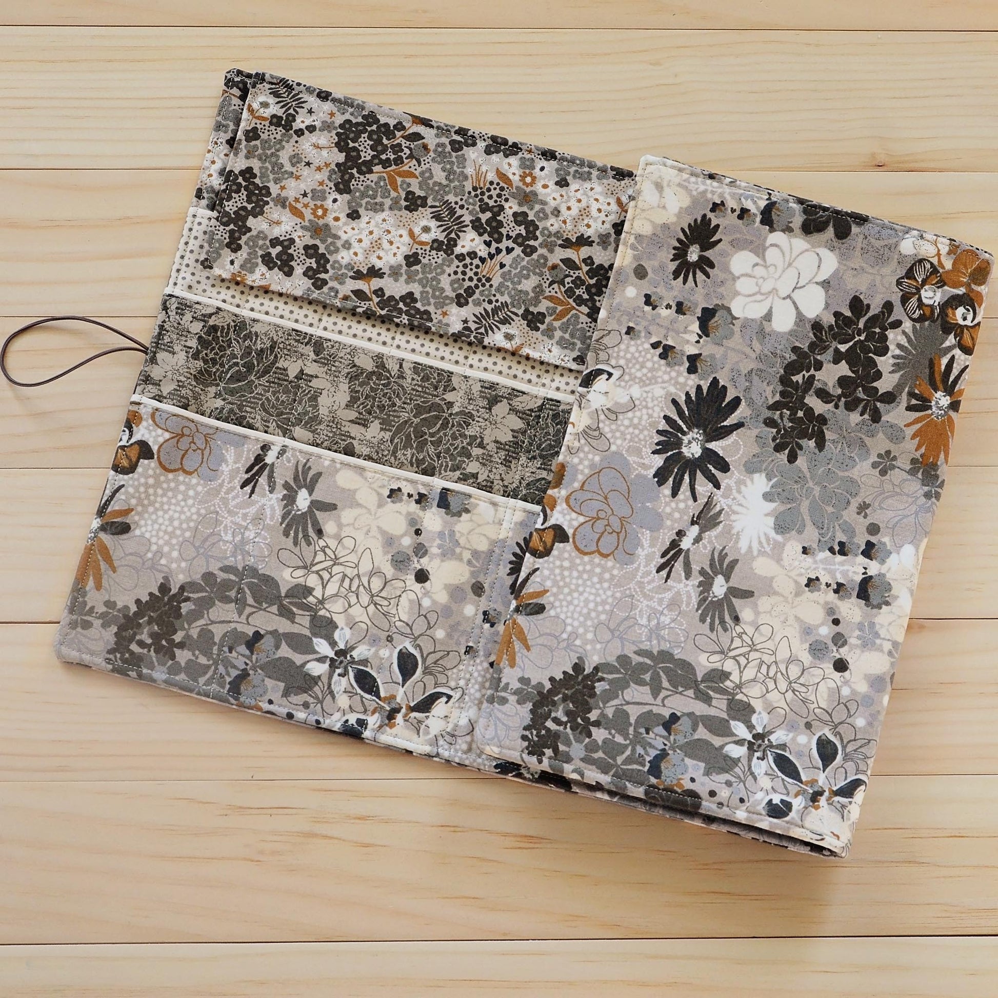 Large knitting needle tri-fold wrap in grey floral with bronze accents.  Made by Yellow Petal Handmade in Nova Scotia, Canada.