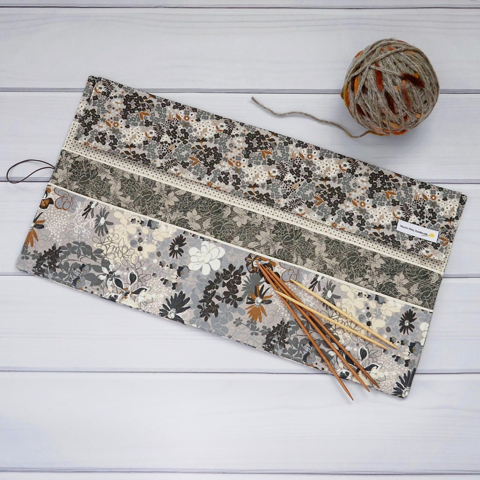 Large knitting needle tri-fold wrap in grey floral with bronze accents.  Made by Yellow Petal Handmade in Nova Scotia, Canada.