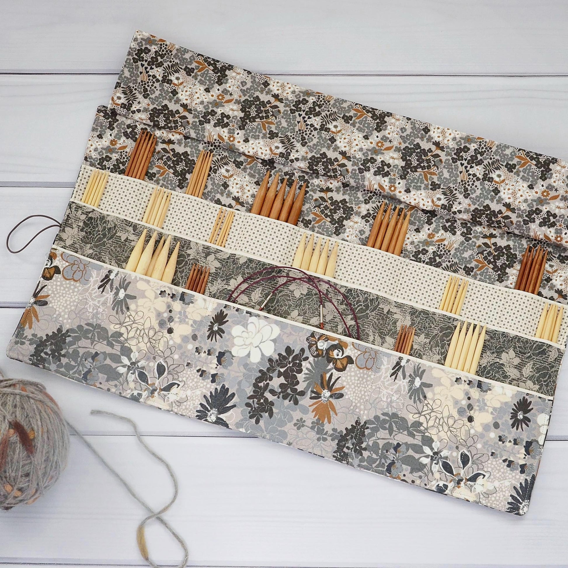 Large knitting needle tri-fold wrap in grey floral with bronze accents.  Made by Yellow Petal Handmade in Nova Scotia, Canada.