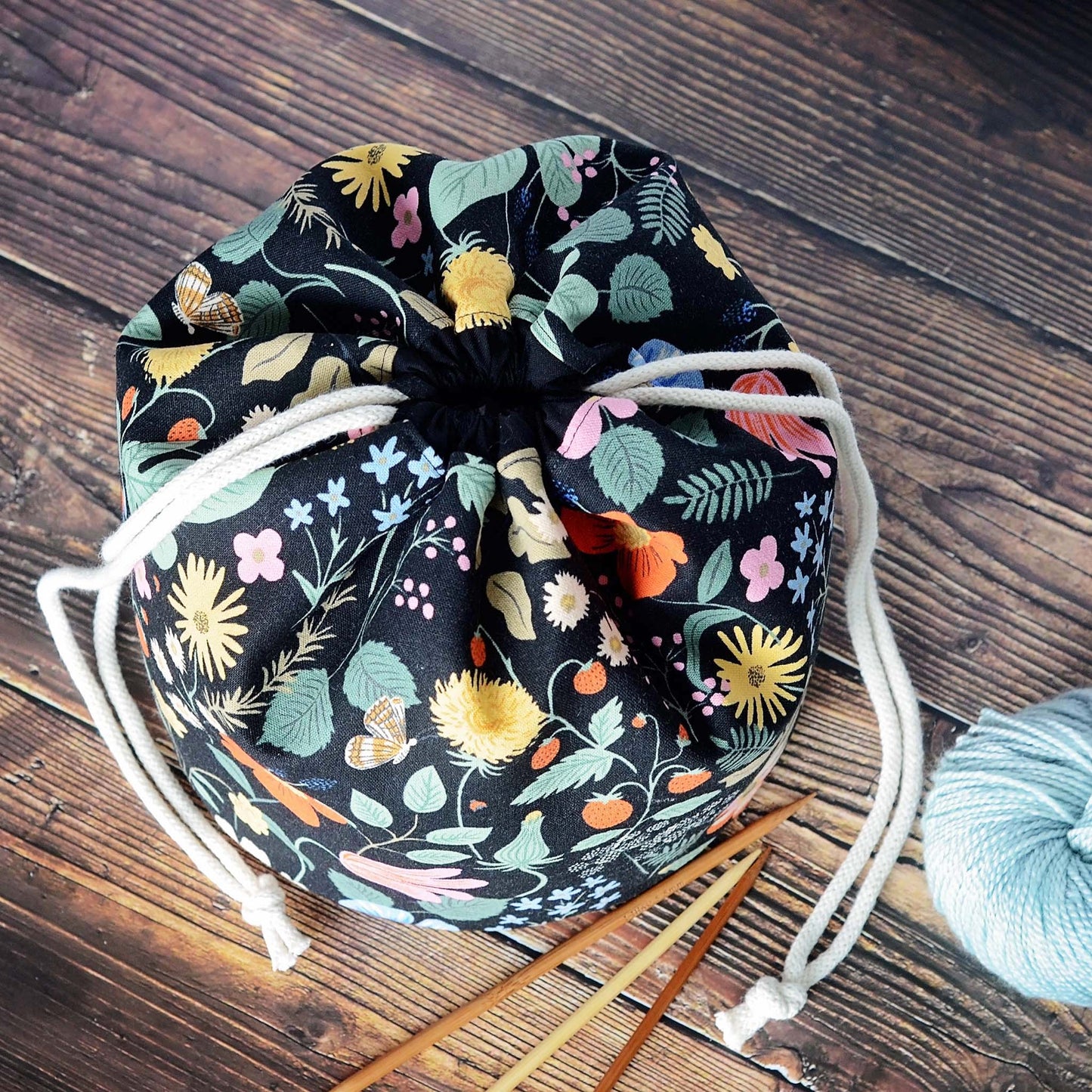 Bucket style knitting bag with multiple pockets.  Made from a black floral canvas from Rifle Paper Co's Strawberry Fields.  Made in Canada by Yellow Petal Handmade.
