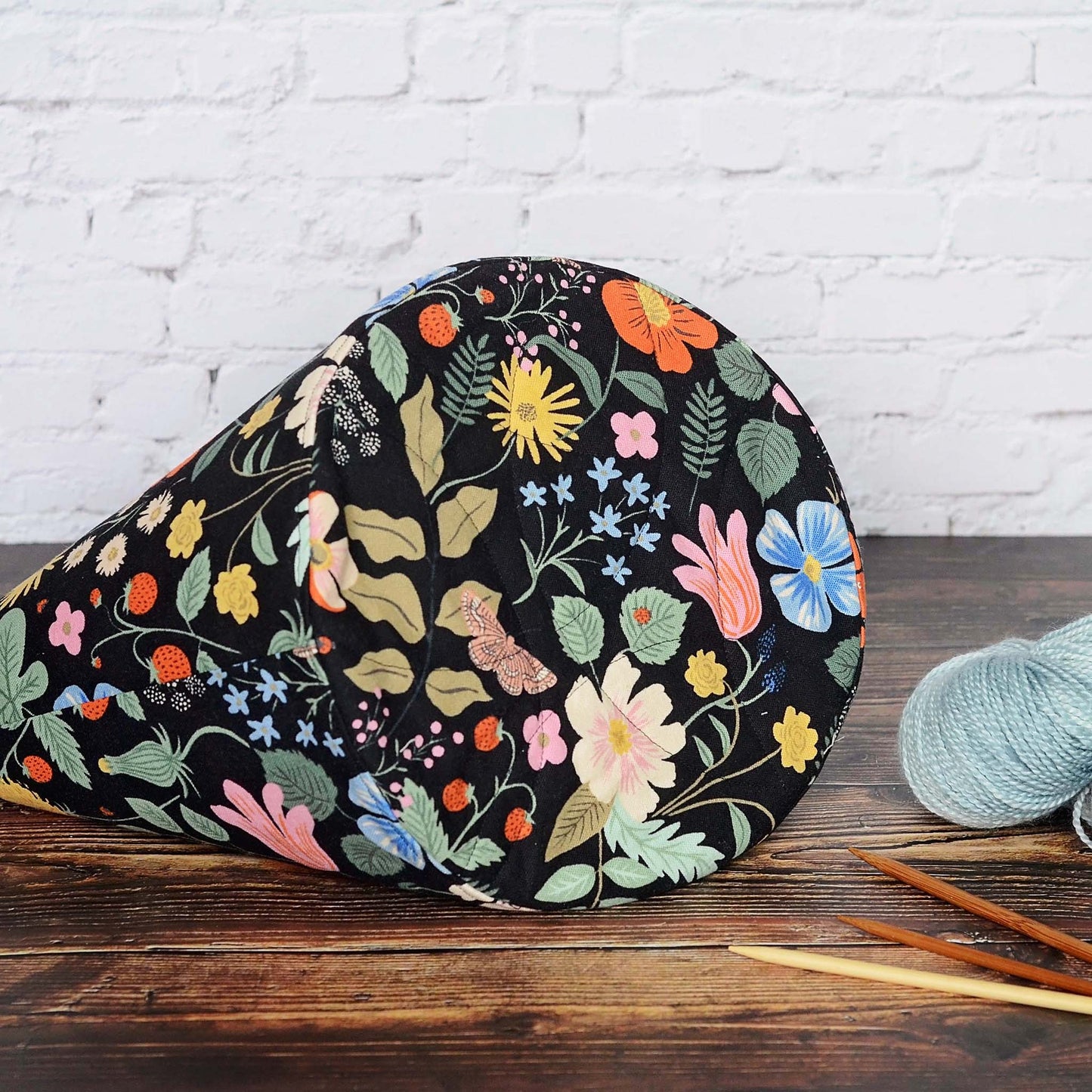 Bucket style knitting bag with multiple pockets.  Made from a black floral canvas from Rifle Paper Co's Strawberry Fields.  Made in Canada by Yellow Petal Handmade.