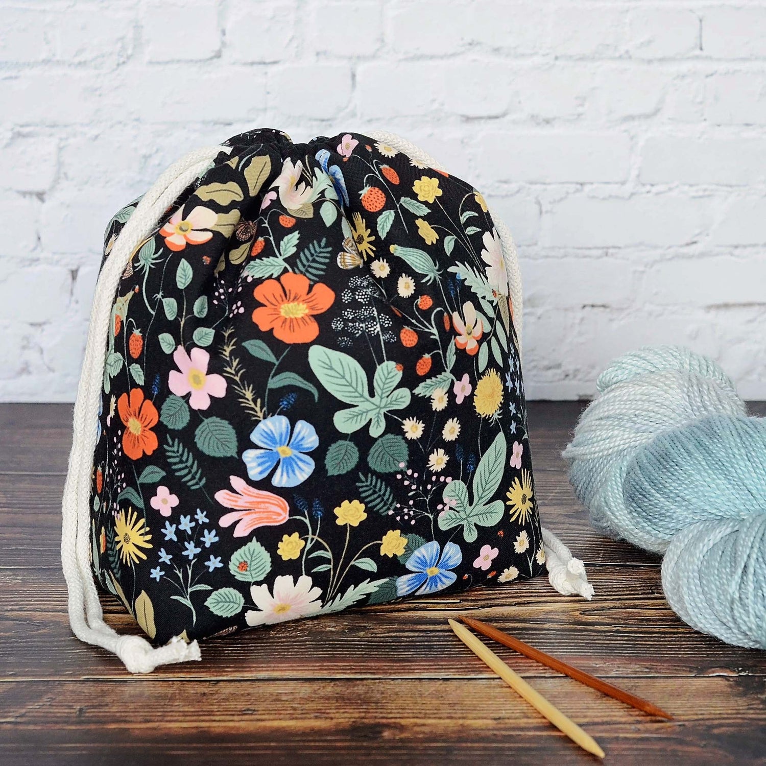 Black floral knitting project bag in Strawberry Fields fabric by Rifle Paper Co.  Lined in a pretty pink floral with pockets.  Made in Canada by Yellow Petal Handmade.