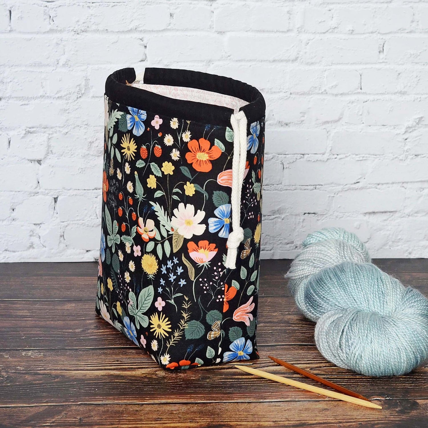 Black floral knitting project bag in Strawberry Fields fabric by Rifle Paper Co.  Lined in a pretty pink floral with pockets.  Made in Canada by Yellow Petal Handmade.