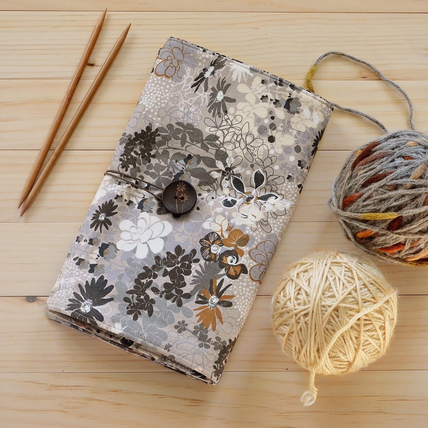 Large knitting needle tri-fold wrap in grey floral with bronze accents.  Made by Yellow Petal Handmade in Nova Scotia, Canada.